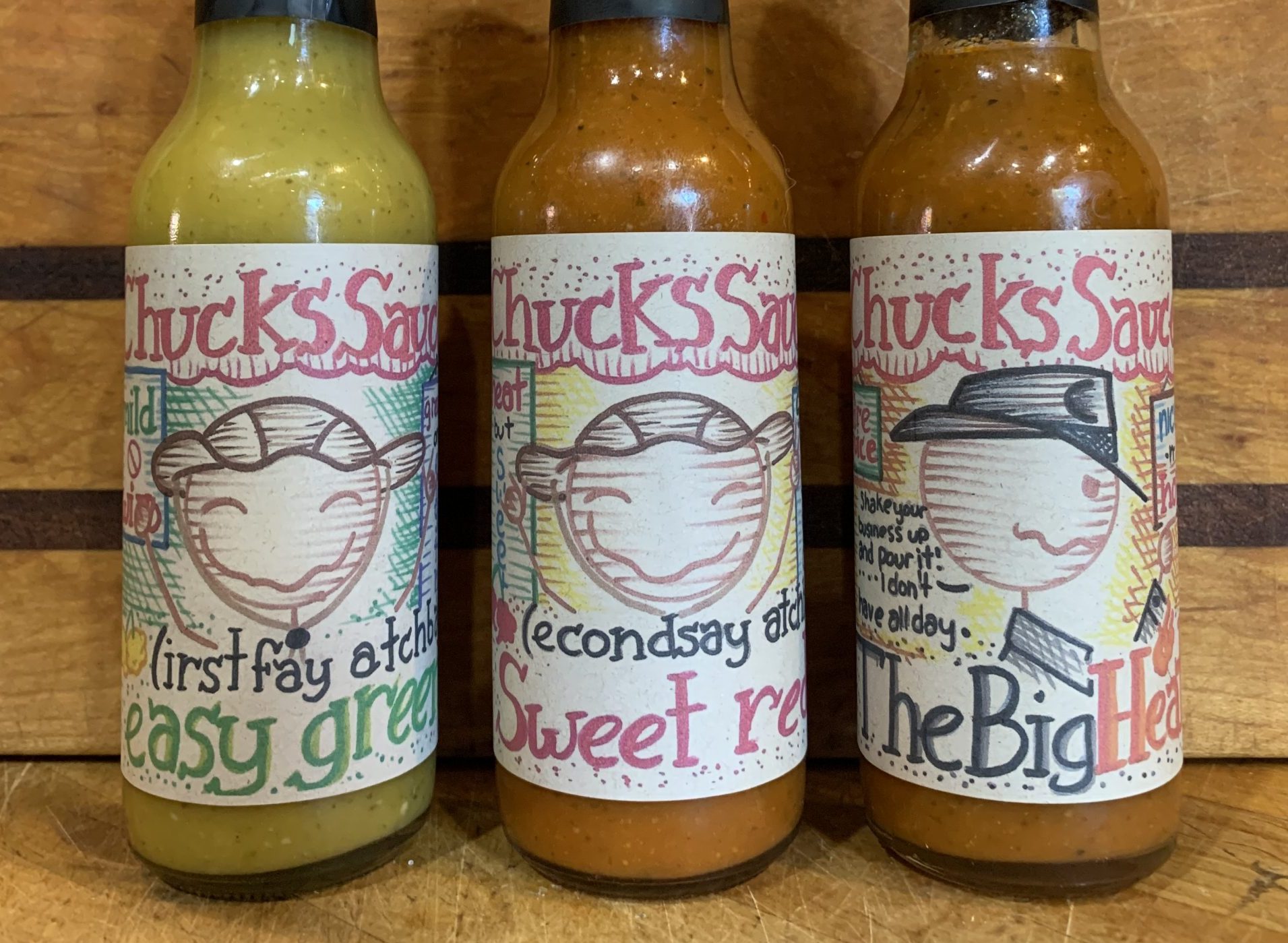 set of three hot sauce bottles